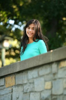 Young teen girl standing on bridge