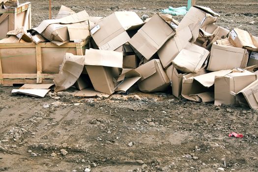 Empty cardboard boxes ready for recycling at a construction site.