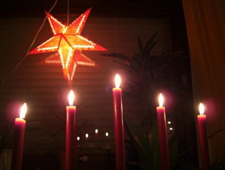 christmas candles and a star in a window