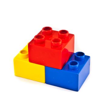 Plastic building blocks on white background. Bright colors.