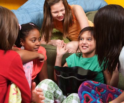 Little girl sharing a joke with her friends 