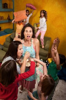 Shocked mother among wild little girls at a sleepover