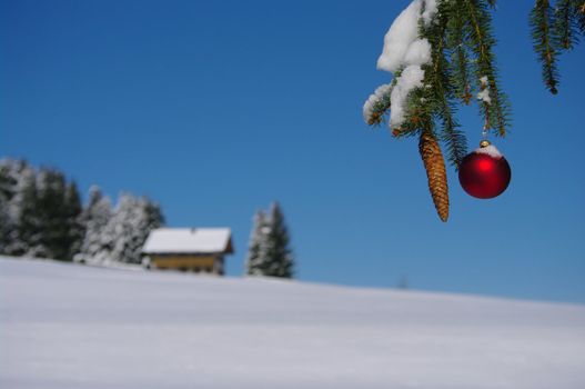 red bauble christmas ball ornament outside in a snowy winter scene