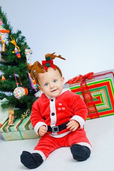 Christmas theme: little Santa - Surprised baby boy with gifts