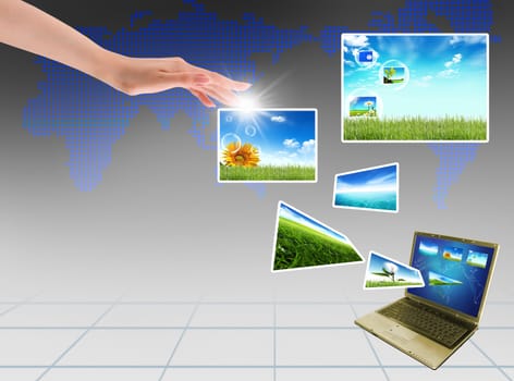 Multimedia concept with modern laptop on green field.
