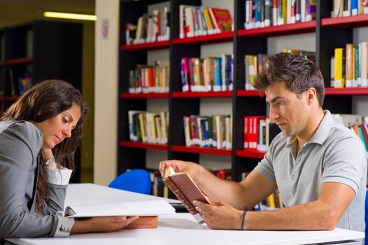 Couple reading together in a public library