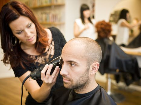 Adult man being shaved at the hair salon