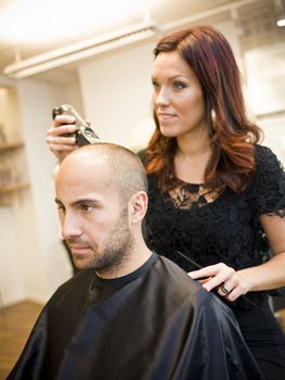 Adult man being shaved at the hair salon