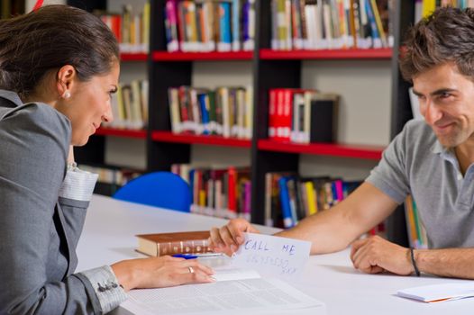 Guy trying to date a girl while in the library