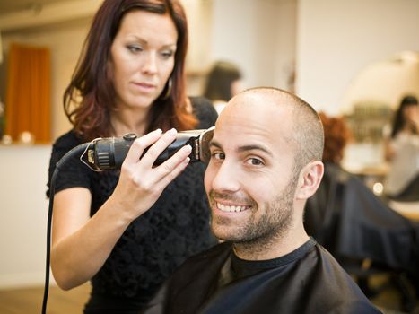 Adult man being shaved at the hair salon