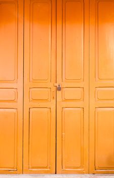 Closeup of an old wood orange door