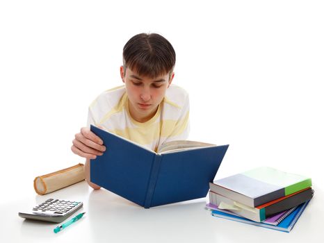 A teenage boy relaxes with study books and accessories.  White background