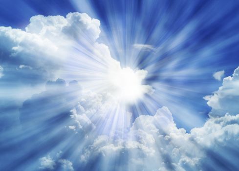 Dramatic blue sky with white clouds and sun rays.