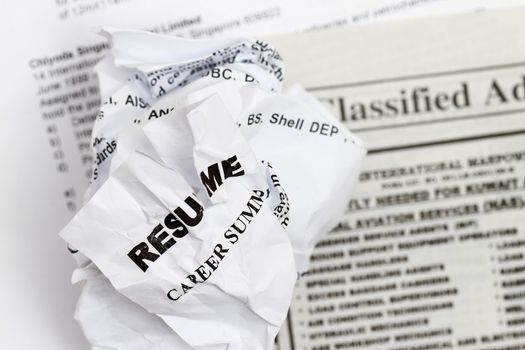 resumes crumpled up and tossed in frustration 

