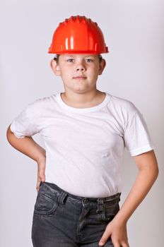 Portrait of a boy in a red protective helmet