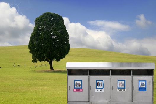 Recycle bins with four categories - many uses for save the environment concept in a spring landscape.