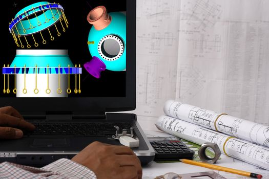 Computer aided design of pressure vessel - many uses in the oil and gas industry. Note: the display in the monitor is my original works 3d of a reactor.