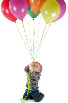 Shot of little cute girl with multicolored air balloons isolated on white