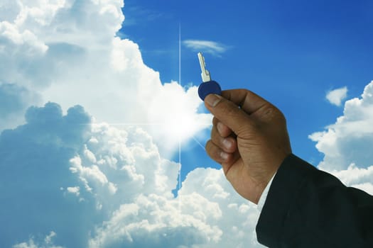 A photo of a bussinessman holding a key with nice blue sky and sunrays-
many uses in the real state industry.