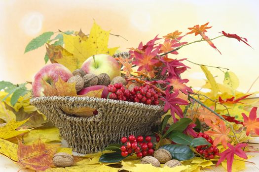 beautiful arrangement of autumn leaves and red apples and walnuts