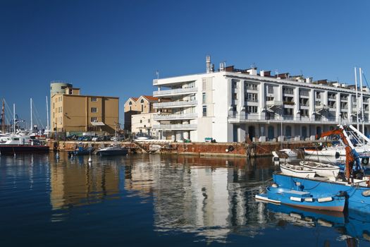 warehouse, fishing boat and sail boat in Genoa port, Italy