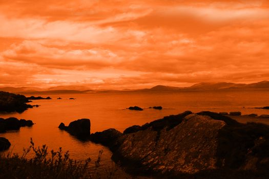 kerry scenic view in ireland with mountains against a beautiful red sunset cloudy sky