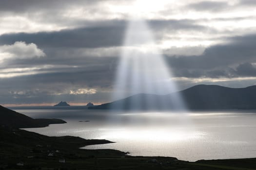 kerry scenic view of the Skellig rocks in ireland with mountains against a beautiful blue cloudy sky