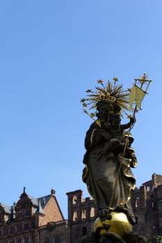 A Statue stands in Heidelberg's "Old City", below its imposing Castle