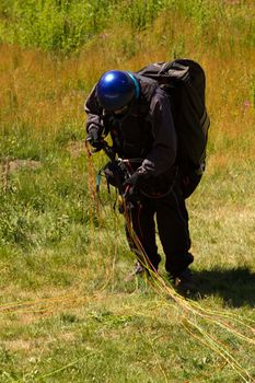 A Paraglider flying from a mountain on a warm summer afternoon