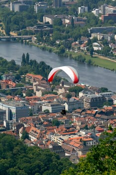 A Paraglider flying from a mountain on a warm summer afternoon