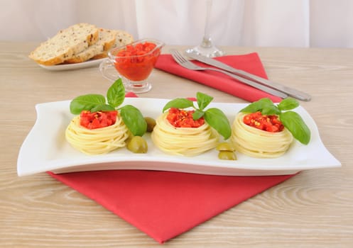 Nest of spaghetti with tomato and basil dressing