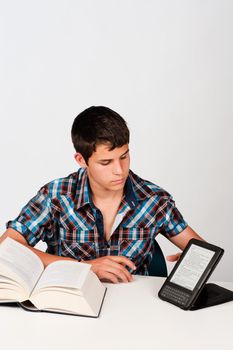 Student comparing a traditional  book with its modern version