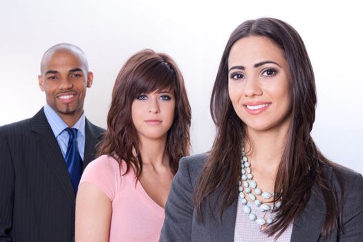 Multicultural business team, three smiling young people.