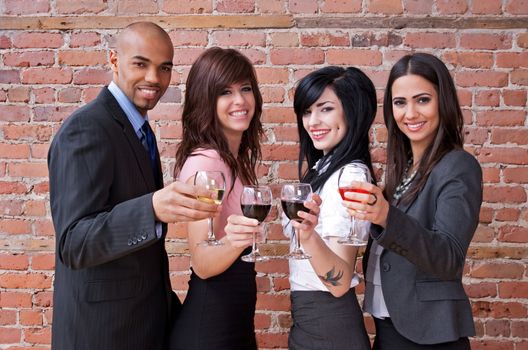 Cheers! Smiling young people with glasses of wine, having fun.