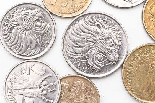 a collection of the different coins of Ethiopian currency including five, ten, twenty five and fifty cents