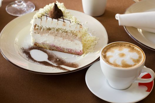 tasty cake at plate closeup with coffee cup