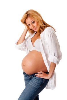 Beautiful new happy mother in late pregnancy wearing fashion jeans, white shirt and bra, isolated.