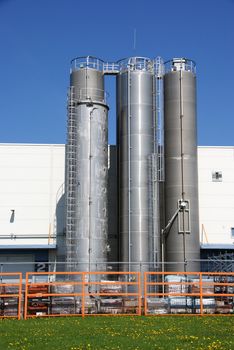 Three industrial bunkers are at a wall of industrial shop