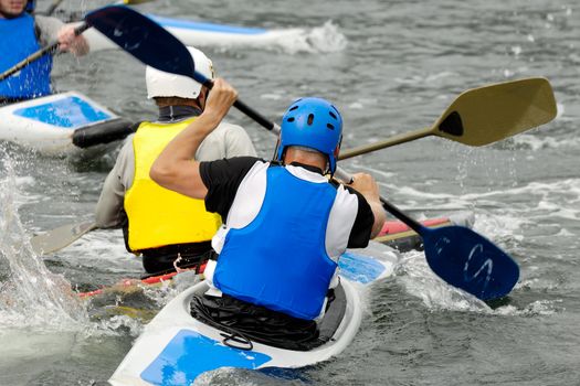 Men are padling in kayaks