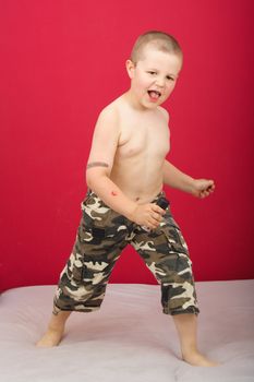 Boy sings boy in military trousers party