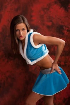 Photo of the young girl in costume of snowmaiden, smiling and posing to the camera