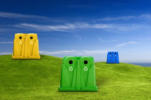 Recycle containers for glass, metal, plastic and paper waste placed on a green meadow lansdscape