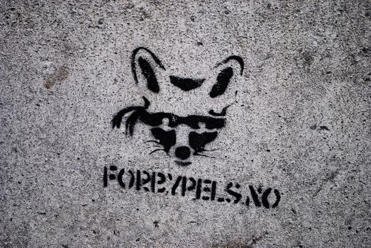A stencil graffiti arguing to ban fur production.