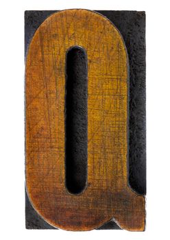 letter Q - vintage wood letterpress printing block, scratched, stained by ink, isolated on white