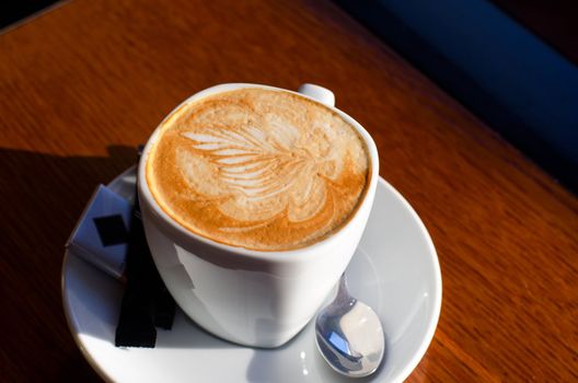 Cappuccino coffee cup closeup at the table