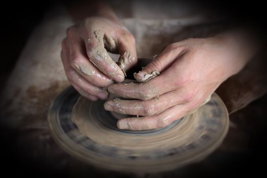Hands of a potter. Loyalty to the traditions concept