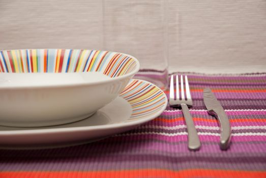 colored striped dishes and cutlery steel