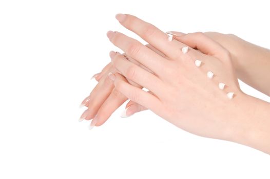 Woman hands with cream over white