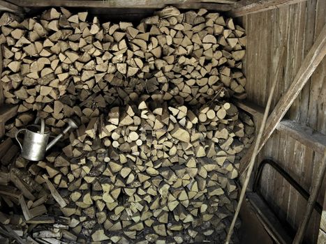 Stacked chopped firewood  woodpile inside a rural cottage