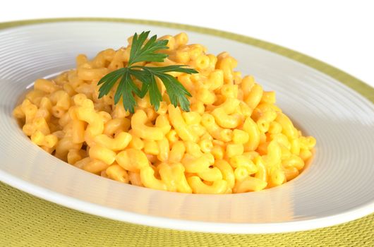 Macaroni and cheese with parsley on top (Selective Focus, Focus on the front of the leaf) 
